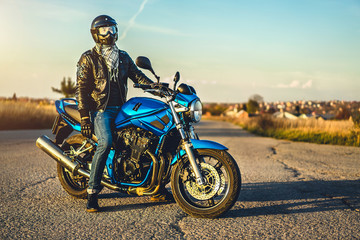 Fototapeta na wymiar Man on sport motorcycle outdoor on the road