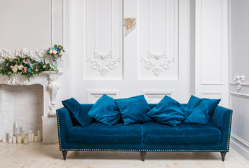 Blue sofa in white classical interior