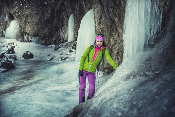 pretty young woman in winter nature, Climber on a frozen waterfall