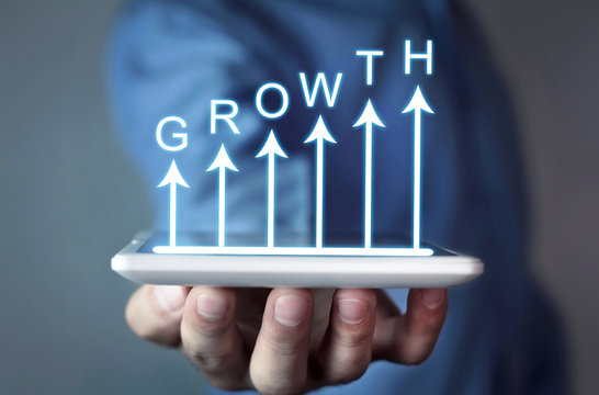 Businessman holding business growth graph.