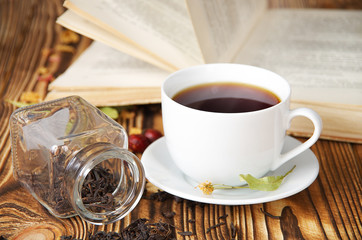 white cup of tea and a book