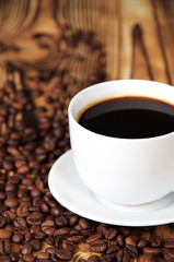 white cup of coffee and coffee beans