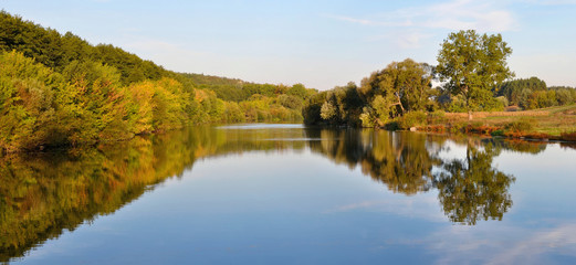 the landscape of the river flowing near the trees