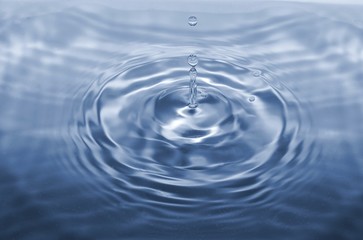 Water drop falling making droplet splash and waves clean and fresh concept
