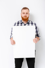 man with beard holding big white card.