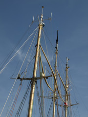 The three masts of the seagoing ship.