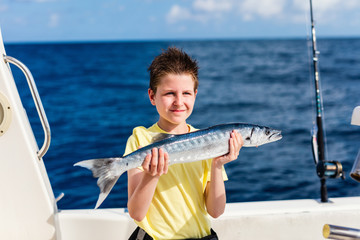 Boy deep sea fishing
