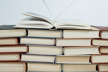 Chaotic stack of old books pastel colors, selective focus with copy space