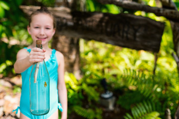 Little girl with treasure bottle