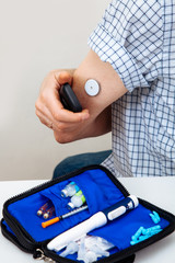 sensor diabetes checkup glucose man system sugar monitoring scan test hand skin medicine syringe table white background