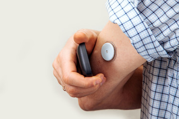 sensor diabetes checkup glucose man system sugar monitoring scan test hand skin medicine syringe table white background