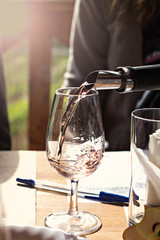 Wine is poured into the glass. Wine tasting.