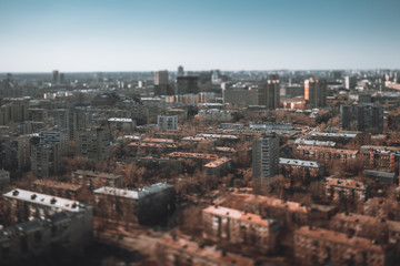True tilt-shift shooting from high above of residential district of a five-story blocks of flats houses, modular prefabricated buildings of the Khrushchev era in Moscow, Russia; bright autumn day
