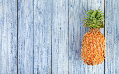 whole pineapple on a light wooden background