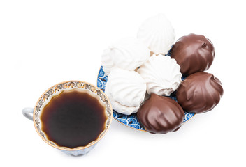 Russian vanilla zephyr, a chocolate-coated zefir on a blue saucer and black coffee