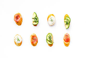 Mini sandwich set with french baguette, cheese and avocado on white background top view