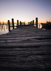 Naklejka premium Damaged dock from hurricane at sunset