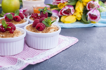 Sweet breakfast with berries in cups. A bouquet of fresh tulips. Spring flowers. Bright details. Free space for text