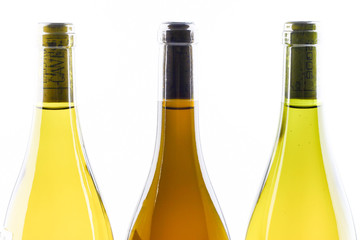 Close up of three bottles of French wine on white background.