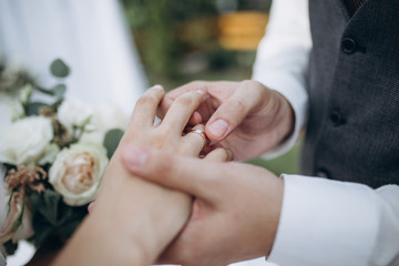 Obraz na płótnie Canvas a man wearing a wedding ring on his wife's finger