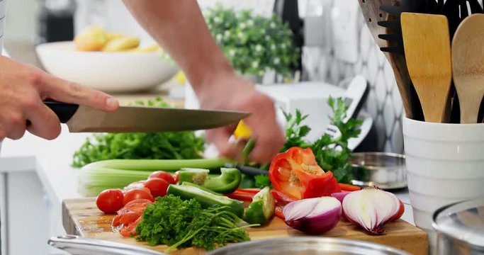 Man cutting vegetables in kitchen at home 