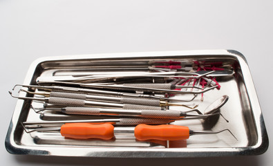 dental equipment in assortment on a metal plate