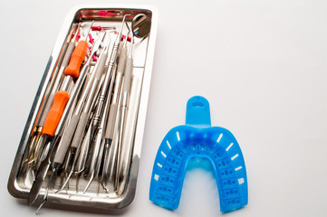 Dental equipment in assortment on a metal plate