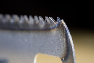 Metal cutting saw under magnification. Hand saw for cutting hard materials.