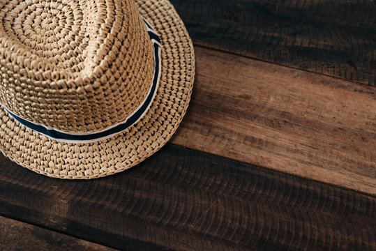 straw hat on a wooden table with copy space.