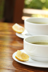 Two plates of hot soup on a summer terrace