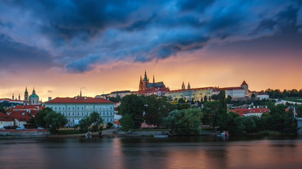Prague old town including Prague castle in the background, one of the most famous landmarks of Prague at sunset with dramatic sky.