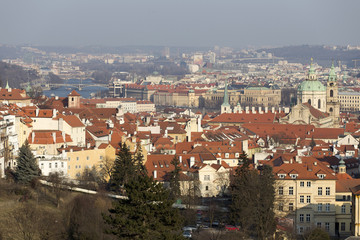 Fototapeta na wymiar Sunny frosty winter Prague City with its Cathedrals, historical Buildings and Towers, Czech Republic