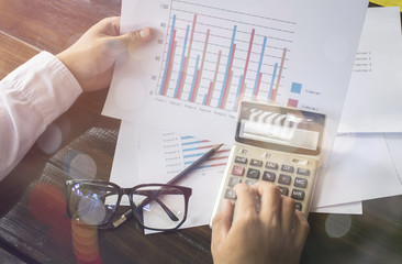 Businessmen use the calculator to calculate and analyze the comp