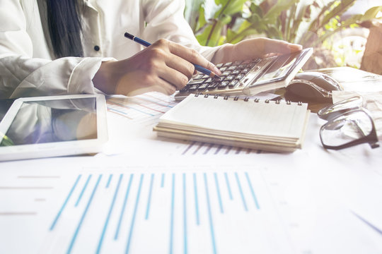 Businessmen use the calculator to calculate and analyze the comp