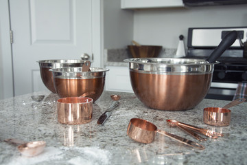 copper metal bowls and cups in kitchen after cooking
