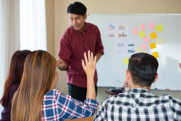 Hand of young Asian women wearing casual plaid shirt is asking for feedback from he colleagues at the Conference about running a successful business. teamwork business meeting