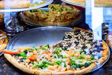 Pizza Take Away pieces on a stall, Traditional Italian Focaccia with tomatoes, black olives and cheese