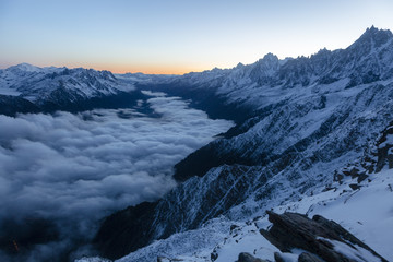 Fototapeta na wymiar Beautiful sharp peaks start to shine as the sun rises in the French Alps