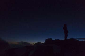 Silhouette of a tourist in the French Alps in the night