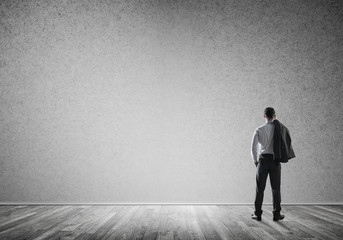 Obraz premium Businessman threw his jacket over his back and looking at blank 