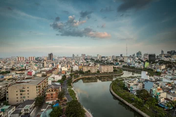 Foto op Canvas HO CHI MINH, VIETNAM - NOV 20, 2017: Royalty high quality stock image aerial view of Ho Chi Minh city, Vietnam. Beauty skyscrapers along river light smooth down urban development in Ho Chi Minh City © binhho image