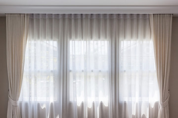 Fototapeta na wymiar White curtain inside the window. Home interior decoration