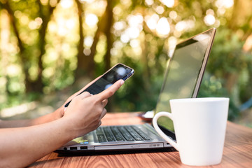 Morning coffee while sitting through a laptop and smartphone.