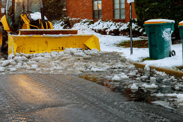 tractor loader cleans snow after a snowfall