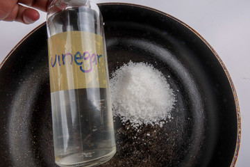 Vinegar and salt is effective to wash corroded black old pan.