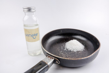 Vinegar and salt is effective to wash corroded black old pan.