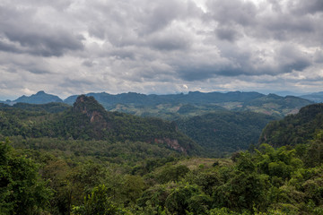 Obraz premium Mountains range view behind the mist of forest and tree, Northern of Thailand in Winter