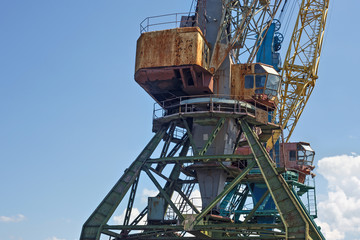 Fototapeta na wymiar Heavy harbour jib cranes in the Kaliningrad Sea Fishing Port.