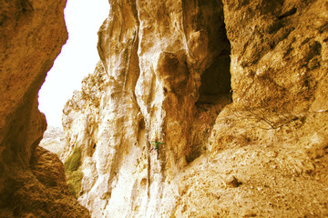 Rock-climbing in Turkey. The climber climbs on the route. Photo from the top.