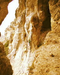 Rock-climbing in Turkey. The climber climbs on the route. Photo from the top.